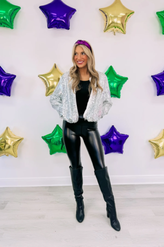 Simple and cute outfit for Mardi Gras with black leather leggings, knee-high boots, black top, and silver sequin bomber jacket