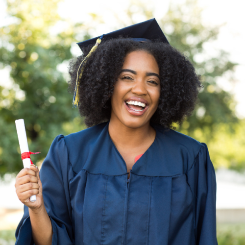 Woman rocking a natural afro hairstyle with a graduation cap